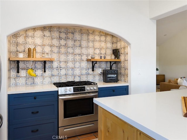535 E Walnut Ave Unit A, El Segundo, CA 90245 - kitchen featuring stainless steel range with gas stovetop, open shelves, tasteful backsplash, light countertops, and blue cabinets