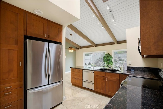 kitchen featuring a sink, a ceiling fan, freestanding refrigerator, brown cabinetry, and electric stove