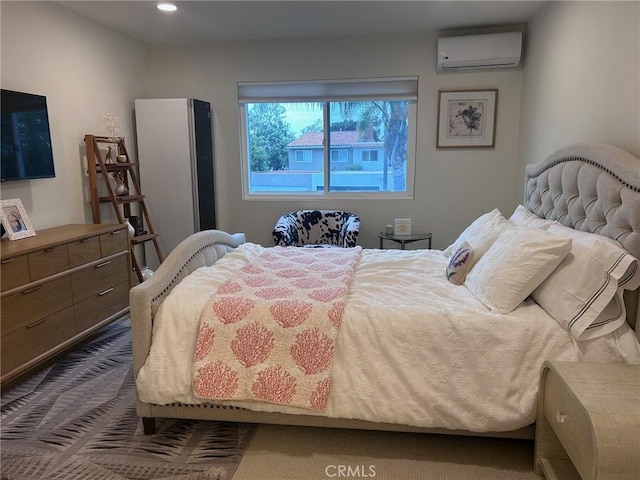 bedroom featuring a wall unit AC and recessed lighting