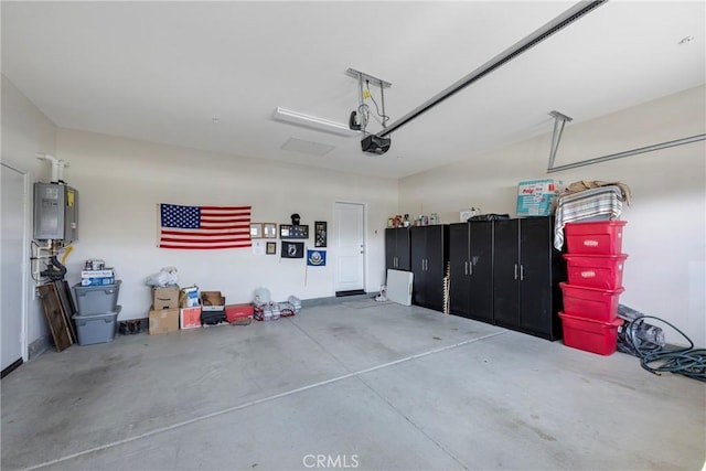 garage with water heater and a garage door opener