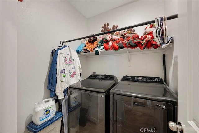 clothes washing area featuring washer and dryer and laundry area
