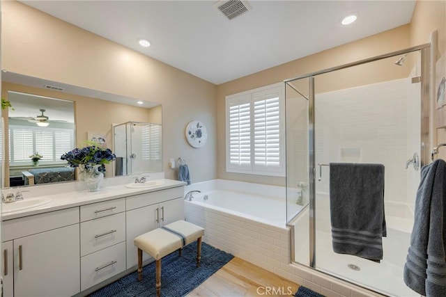 full bath with a stall shower, double vanity, visible vents, and a sink