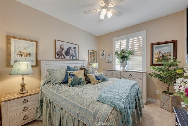 bedroom featuring baseboards, ceiling fan, and light colored carpet