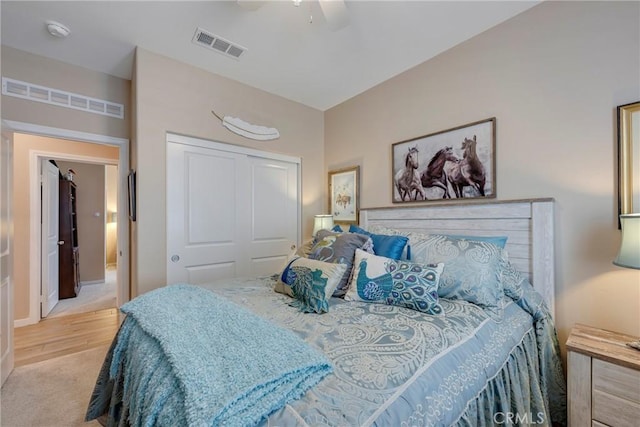 bedroom with a closet, visible vents, and a ceiling fan