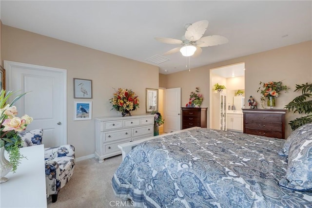 bedroom with visible vents, baseboards, a ceiling fan, ensuite bath, and light colored carpet