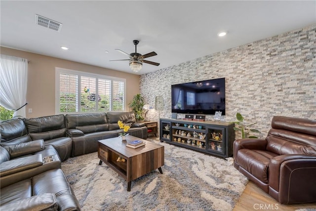 living room with a ceiling fan, recessed lighting, wood finished floors, and visible vents