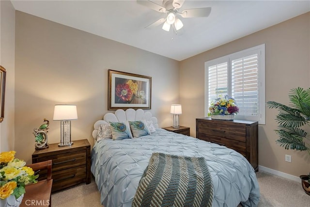 bedroom featuring light carpet, baseboards, and a ceiling fan