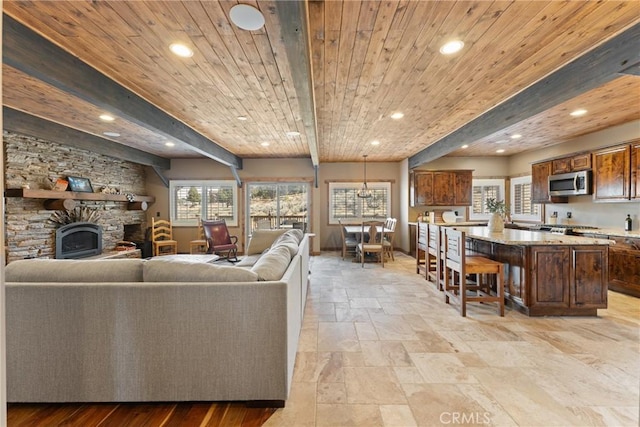 1985 Golden Rod Ave, Big Bear City, CA 92314 - living area with wood ceiling, a stone fireplace, beam ceiling, and recessed lighting