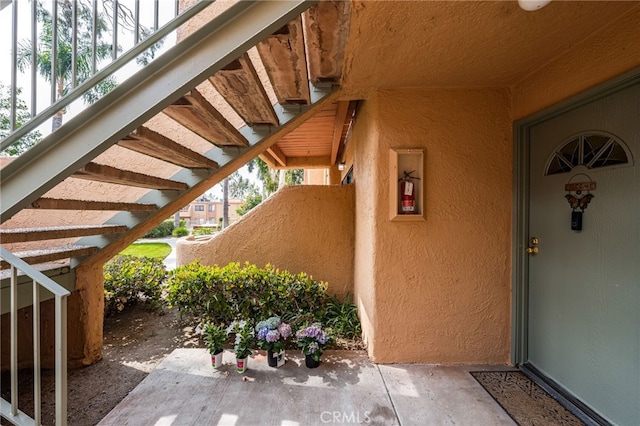 view of exterior entry featuring stucco siding