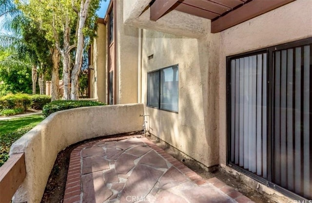 view of side of home with stucco siding
