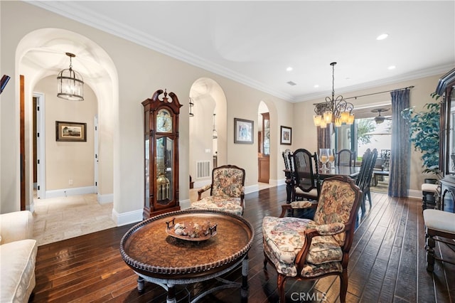 dining space featuring a chandelier, arched walkways, and hardwood / wood-style floors