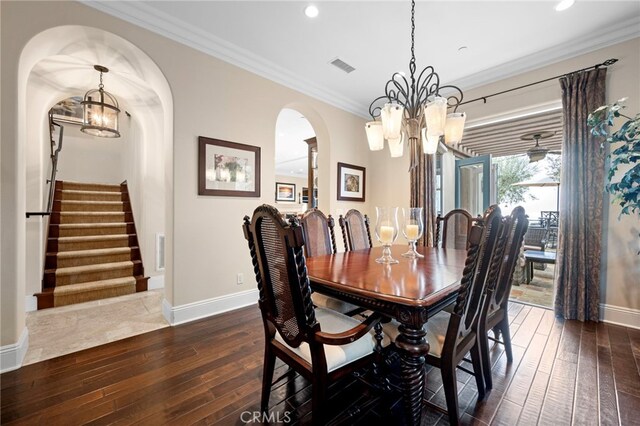 28 Surfspray Blf, Newport Coast, CA 92657 - dining area featuring a chandelier, dark wood-type flooring, arched walkways, stairs, and ornamental molding