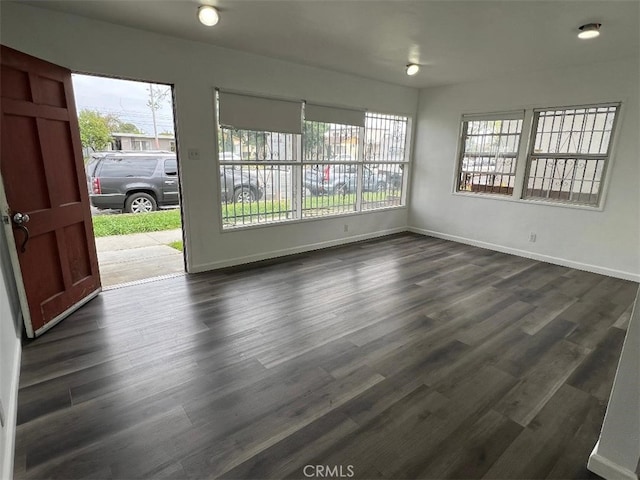 2223 W Olympic Blvd, Montebello, CA 90640 - spare room featuring baseboards and dark wood-style flooring
