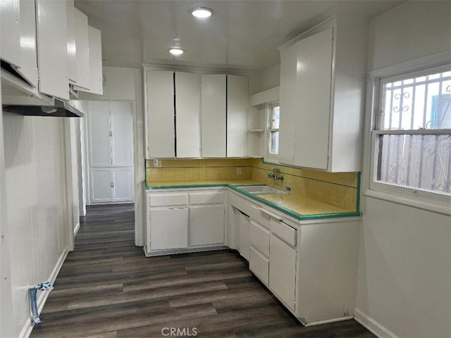 2223 W Olympic Blvd, Montebello, CA 90640 - kitchen featuring dark wood-type flooring, tile counters, a sink, and white cabinetry