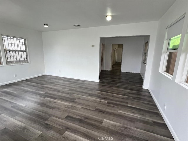 2223 W Olympic Blvd, Montebello, CA 90640 - spare room with visible vents, baseboards, and dark wood-style flooring
