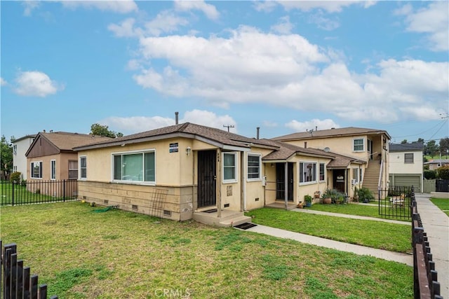 view of front facade with stucco siding, fence, crawl space, and a front yard