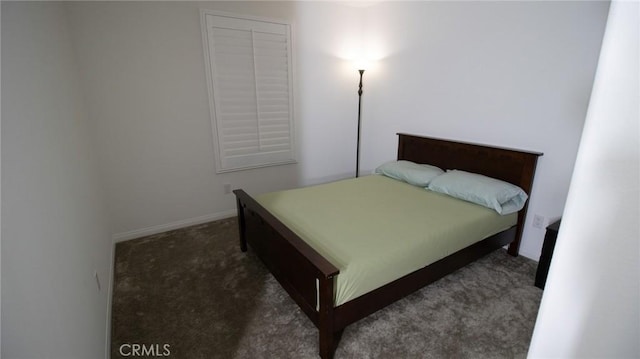 bedroom with carpet floors and baseboards