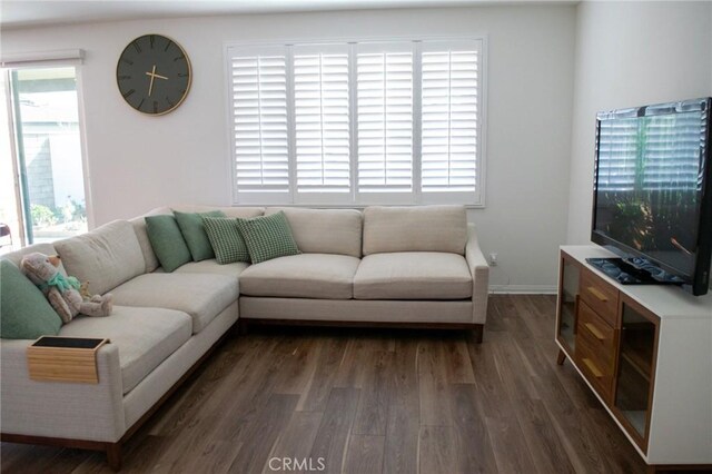 living area featuring baseboards and wood finished floors