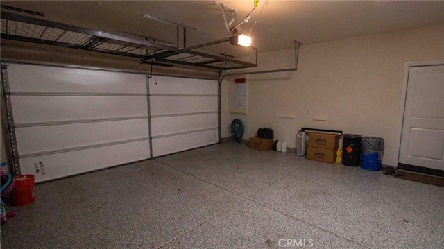 garage featuring a garage door opener and electric panel