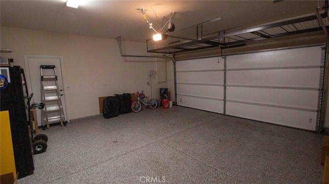 garage featuring freestanding refrigerator and a garage door opener