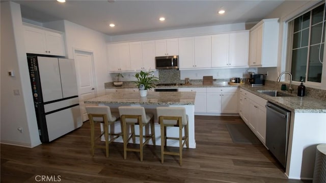 kitchen with white cabinets, appliances with stainless steel finishes, and a sink