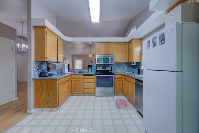 kitchen featuring decorative backsplash, appliances with stainless steel finishes, and light floors