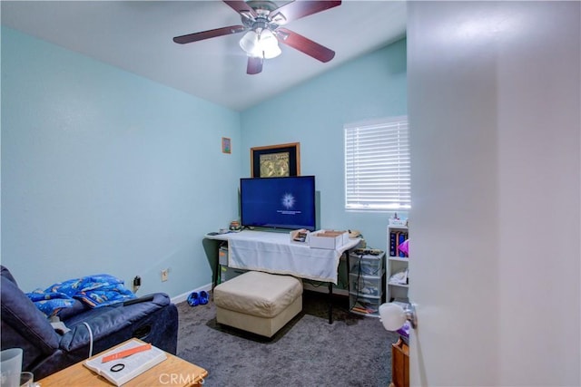 interior space featuring baseboards, vaulted ceiling, and a ceiling fan