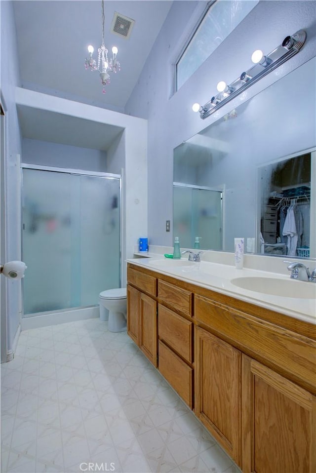 full bathroom featuring visible vents, a sink, double vanity, and a shower stall