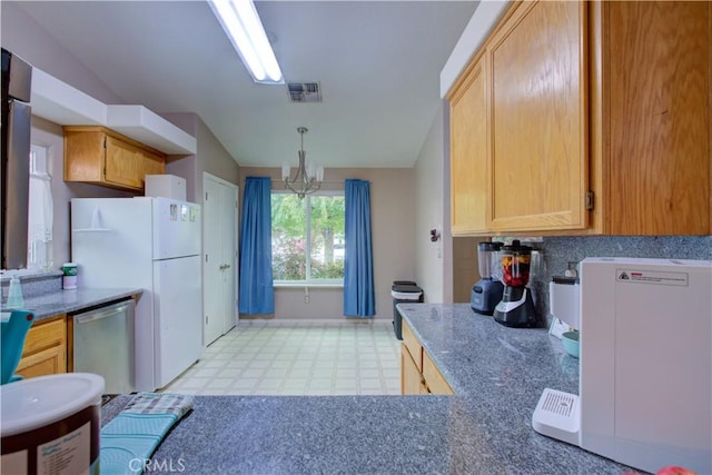 kitchen featuring light floors, stainless steel dishwasher, lofted ceiling, visible vents, and an inviting chandelier