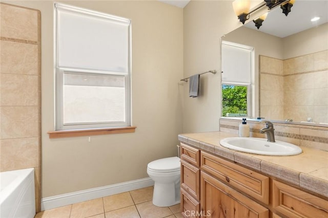 full bath with vanity, a tub, toilet, baseboards, and tile patterned flooring