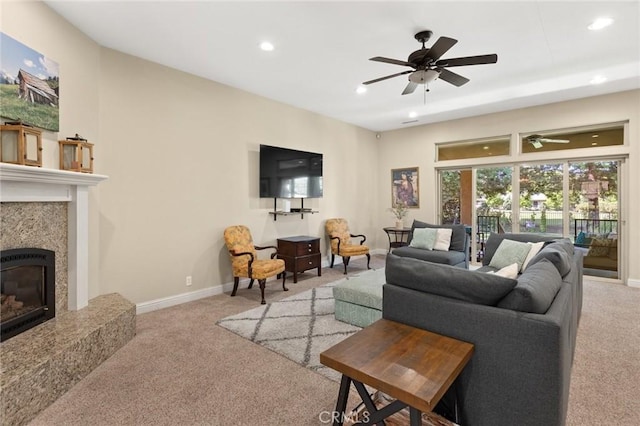carpeted living room with a fireplace, recessed lighting, a ceiling fan, and baseboards