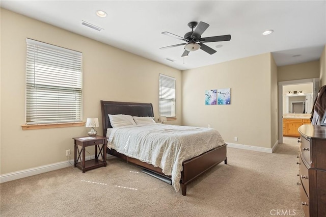 bedroom with a ceiling fan, visible vents, light colored carpet, and baseboards