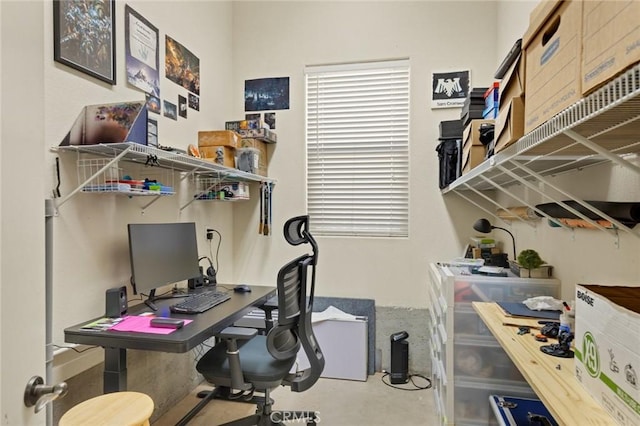 home office with concrete flooring