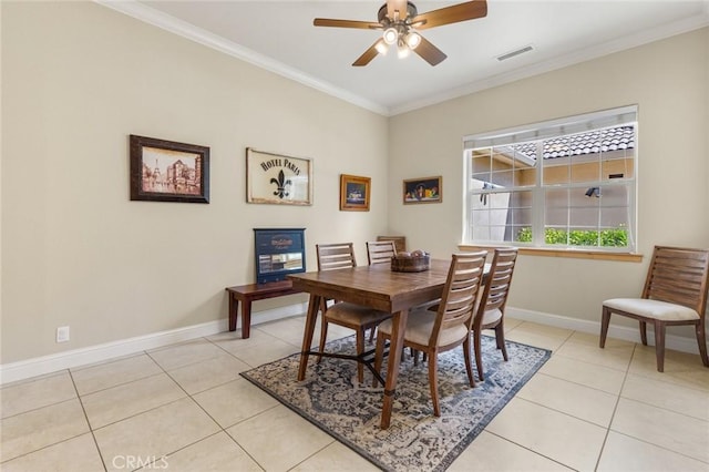 dining space with light tile patterned floors, visible vents, a ceiling fan, and baseboards