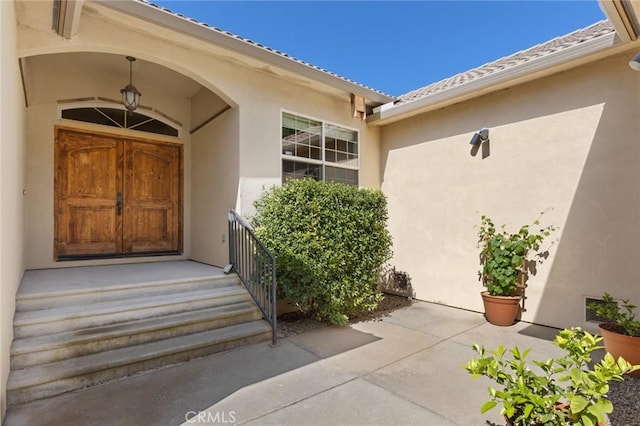 property entrance with stucco siding