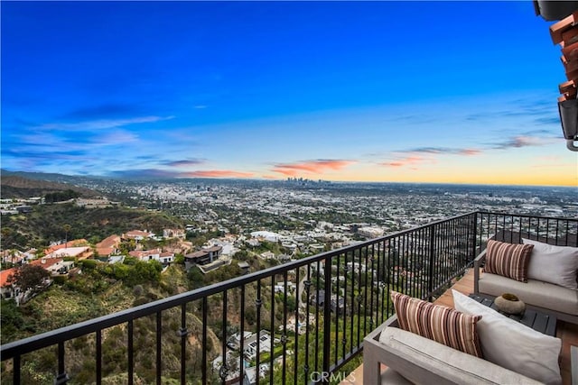 balcony at dusk with an outdoor hangout area