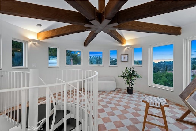 interior space with beam ceiling and a wealth of natural light