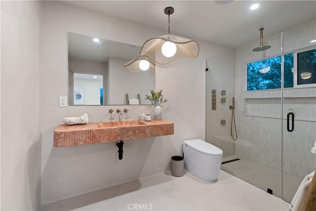 full bathroom with toilet, a sink, recessed lighting, and a shower stall