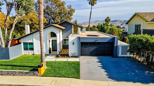 32772 Shipside Dr, Dana Point, CA 92629 - mid-century home with an attached garage, driveway, a mountain view, a chimney, and stucco siding