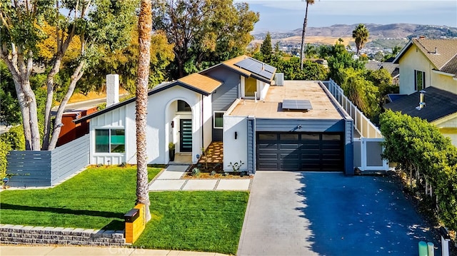 32772 Shipside Dr, Dana Point, CA 92629 - mid-century inspired home featuring a garage, solar panels, driveway, a mountain view, and stucco siding