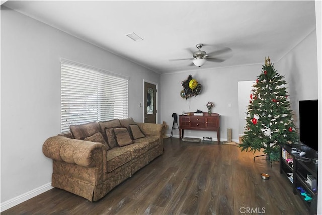 living area featuring wood finished floors, a ceiling fan, visible vents, and baseboards