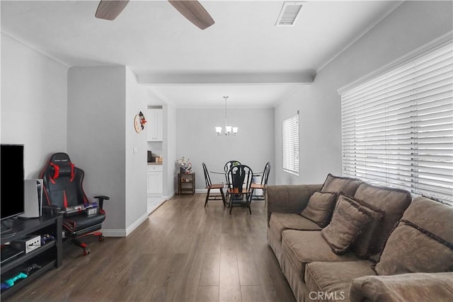 living room with wood finished floors, baseboards, visible vents, and ceiling fan with notable chandelier