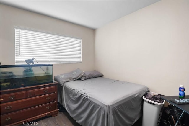 bedroom with dark wood-style flooring