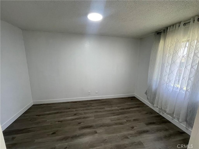 14802 Newport Unit 2B, Tustin, CA 92780 - empty room featuring a textured ceiling and dark wood finished floors