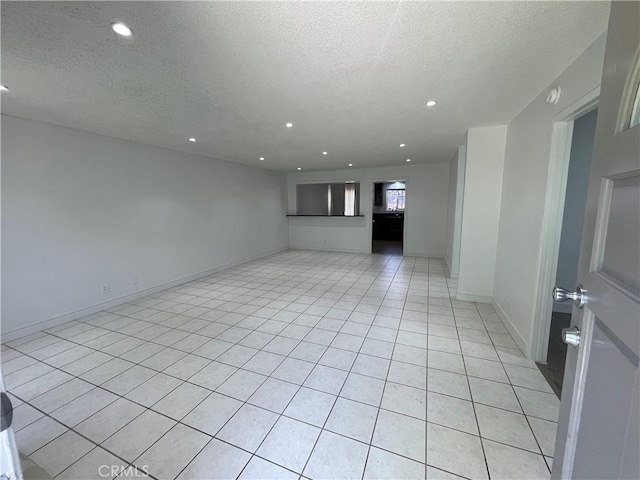 14802 Newport Unit 2B, Tustin, CA 92780 - spare room with a textured ceiling, recessed lighting, light tile patterned floors, and a smoke detector