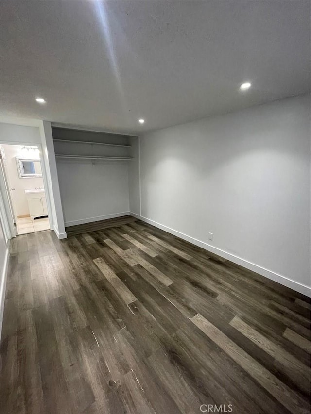14802 Newport Unit 2B, Tustin, CA 92780 - unfurnished bedroom featuring recessed lighting, dark wood finished floors, and a closet