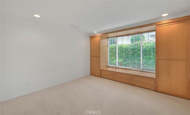 unfurnished room featuring recessed lighting, baseboards, light colored carpet, and ornamental molding