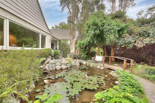 view of yard with a garden pond
