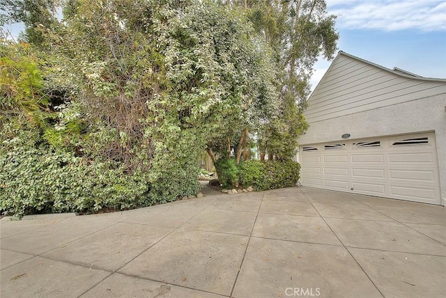 exterior space with driveway and stucco siding