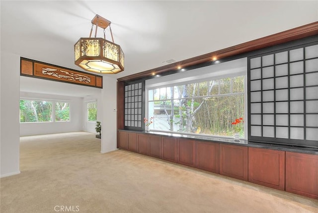 unfurnished room with visible vents and light carpet